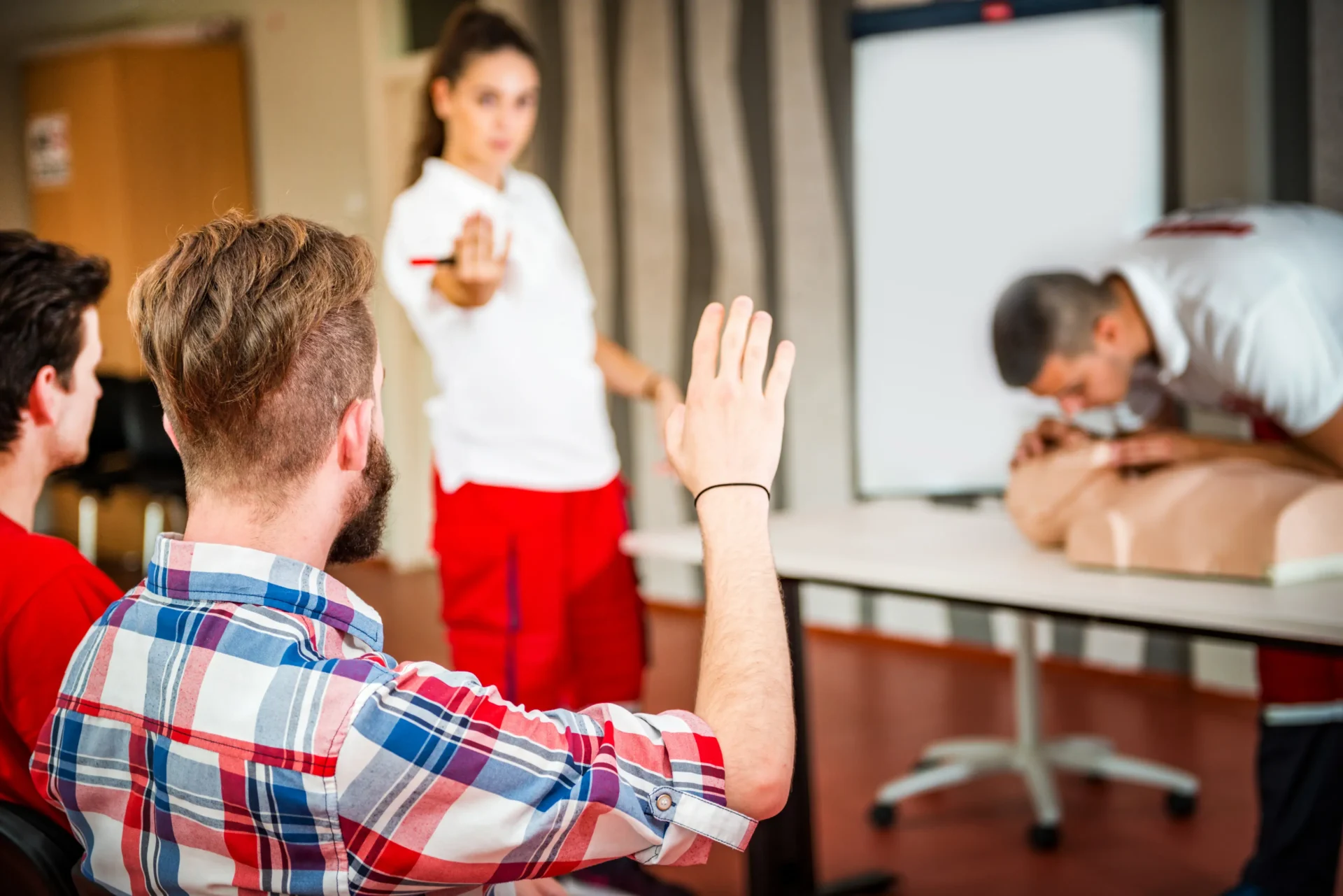 First aid class student raising hand.