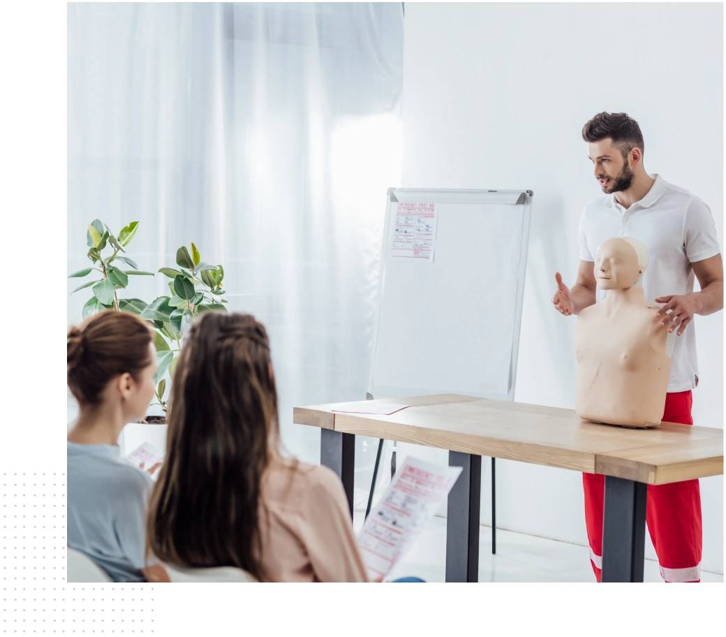 Instructor teaching CPR to students.